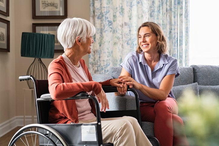 Compassionate caregiver with elderly resident with dementia