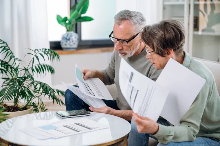 Senior couple reviewing Medicaid paperwork and payment options